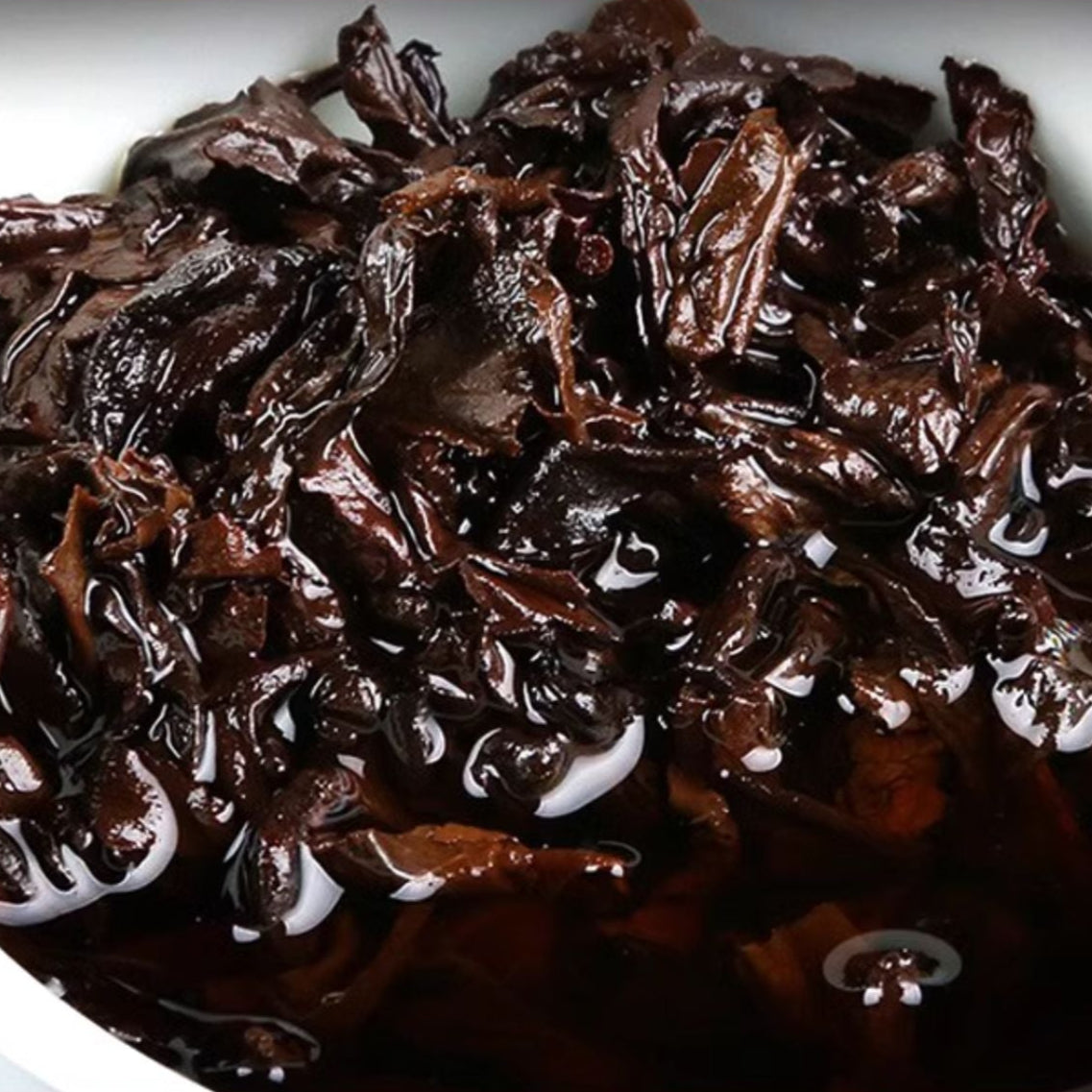 a zoom on ripe pu erh wet tea leaves