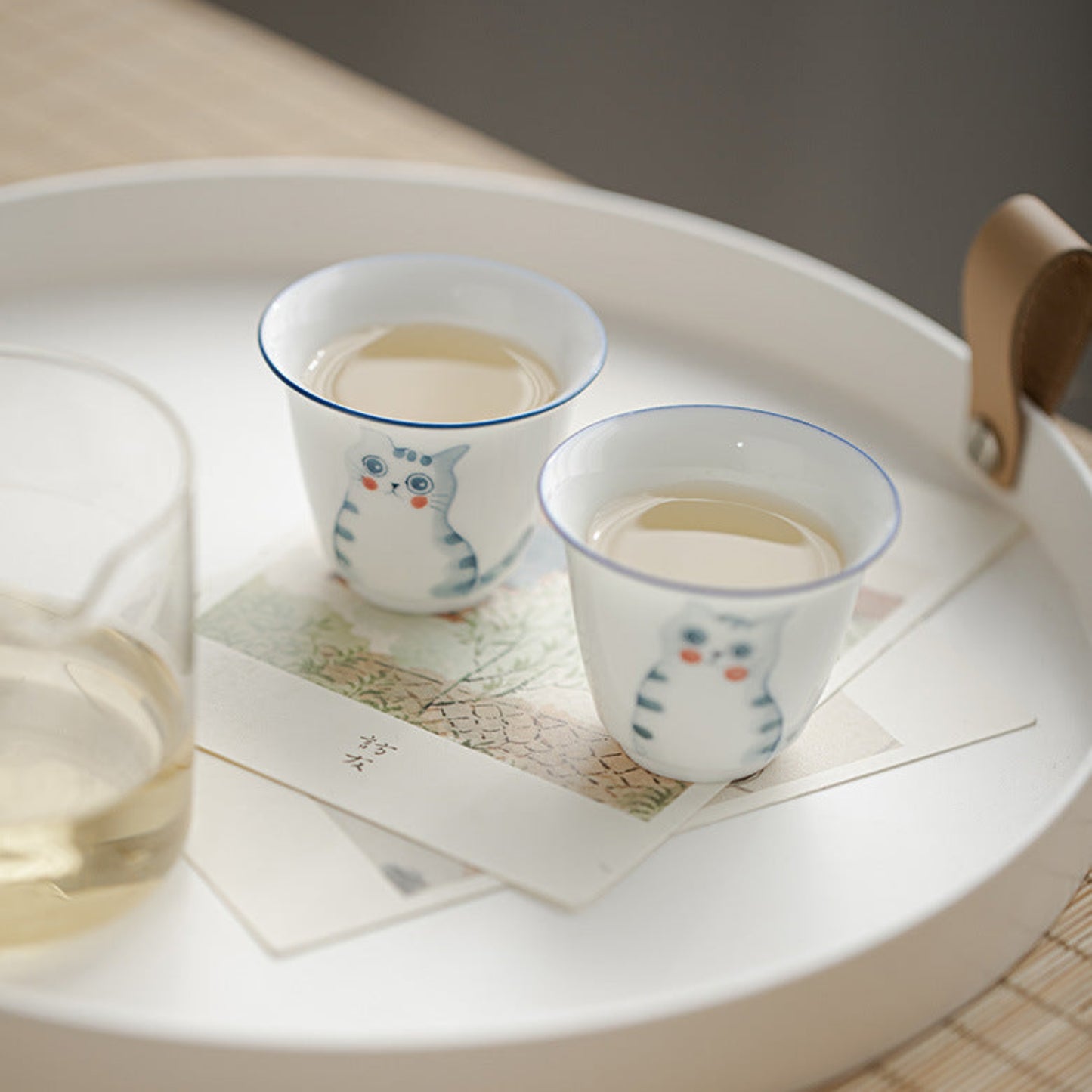 gongfu cups full of green tea on a tray