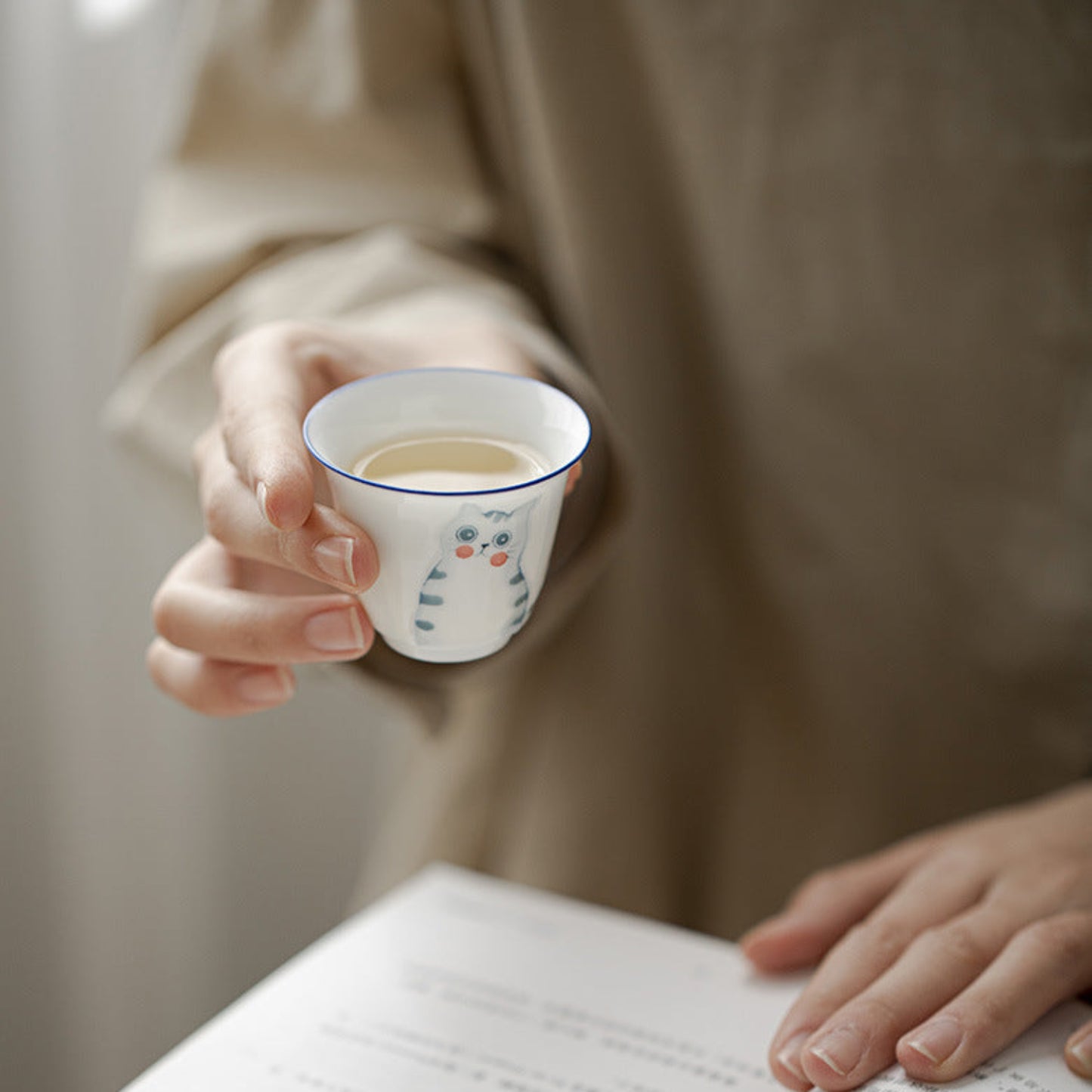 drinking a cup of tea while reading 
