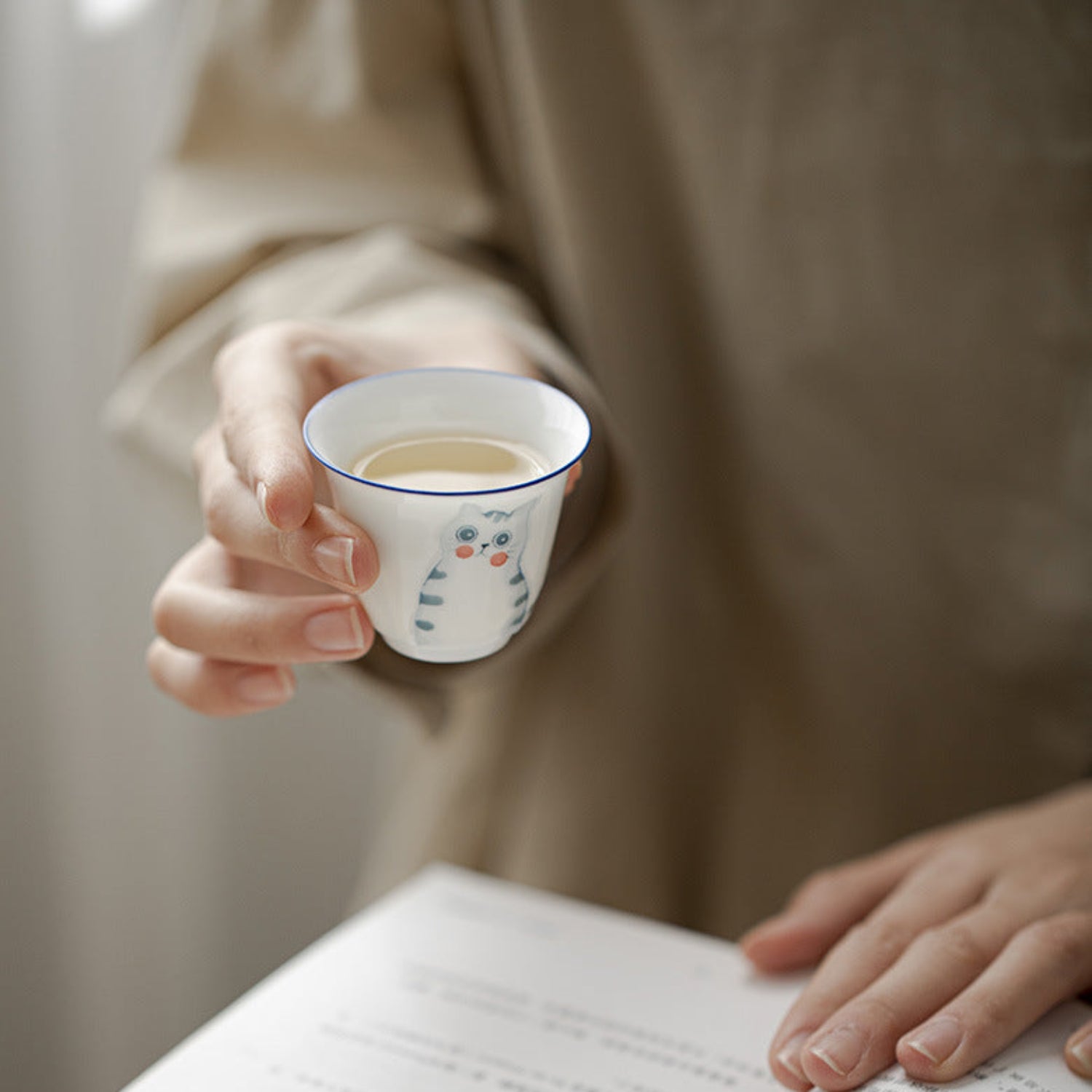 drinking a cup of tea while reading 