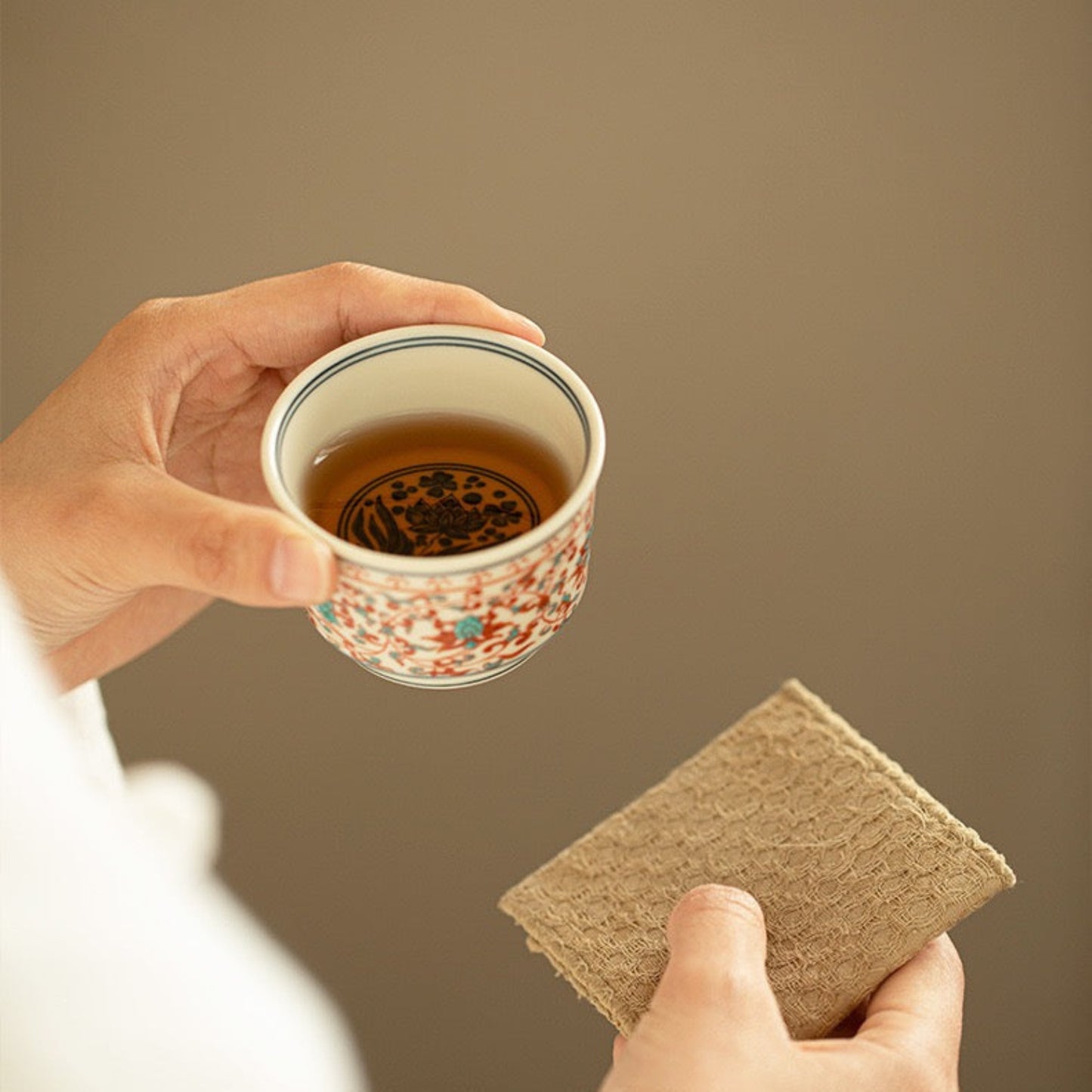 drinking a cup of tea with a Chinese tea cup
