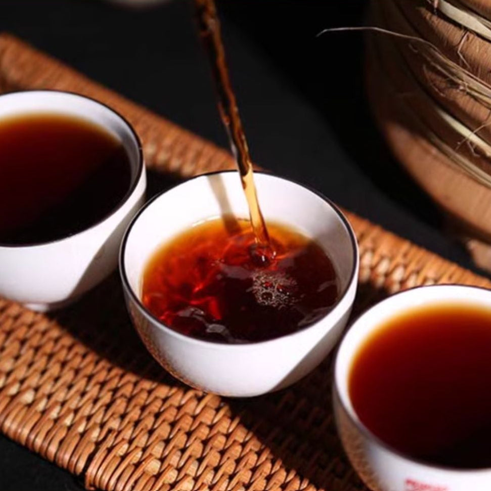 pouring a cup of fermented ripe pu erh dark tea 