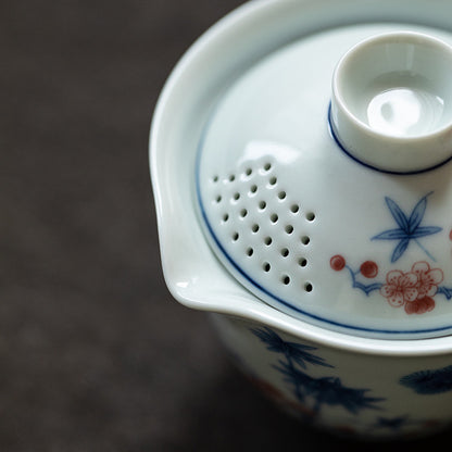 Close-up of a ceramic teapot with floral designs on a dark background
