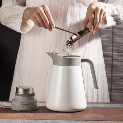 adding tea leaves to a vacuum thermos jug