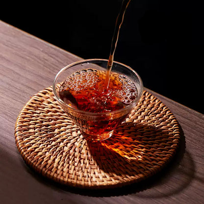 pouring Chinese tea in a glass cup