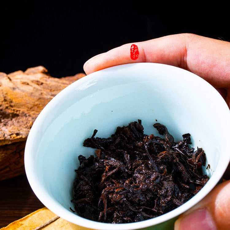 wet pu erh tea leaves in a gaiwan 
