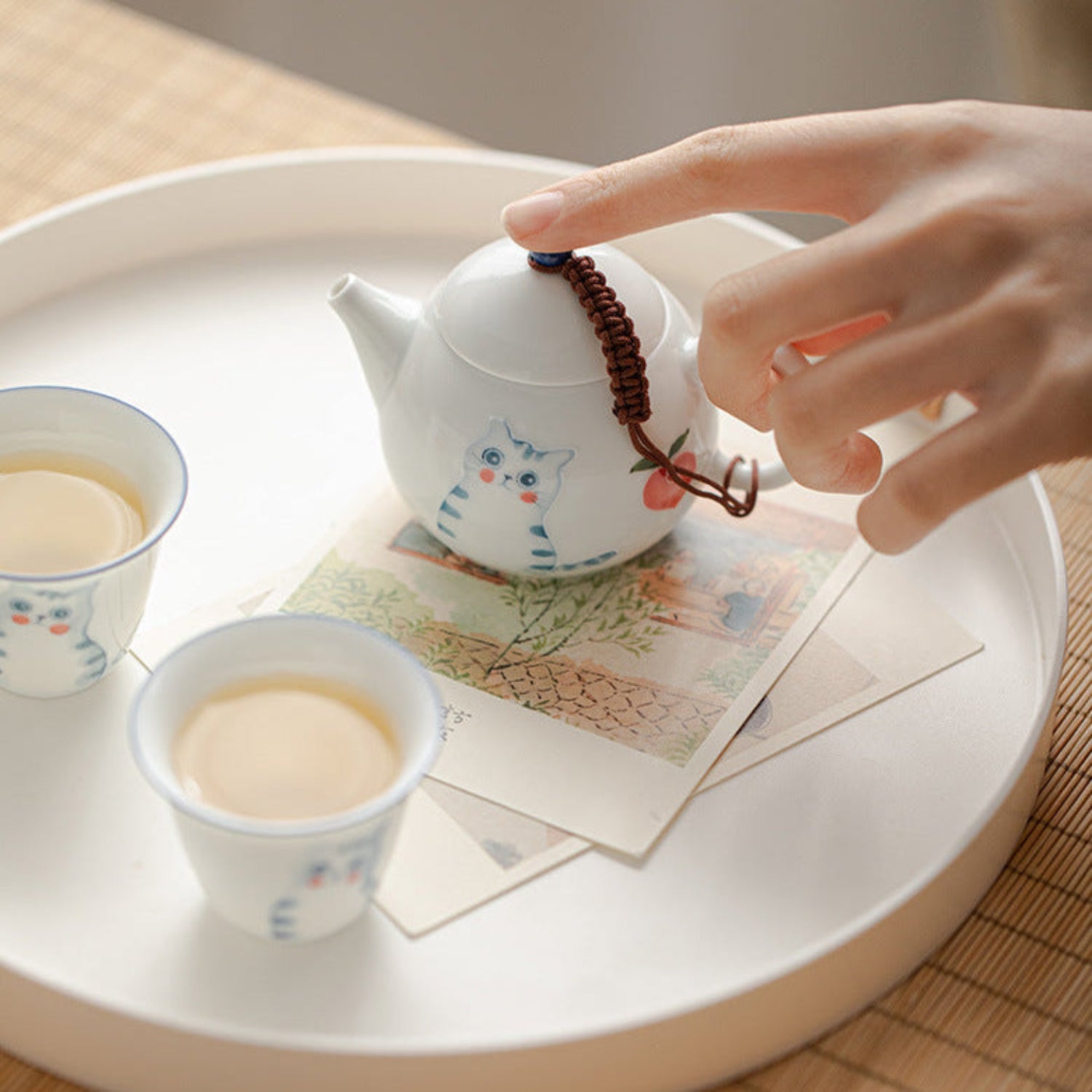 Chinese tea prepared with cute cat porcelain teaware