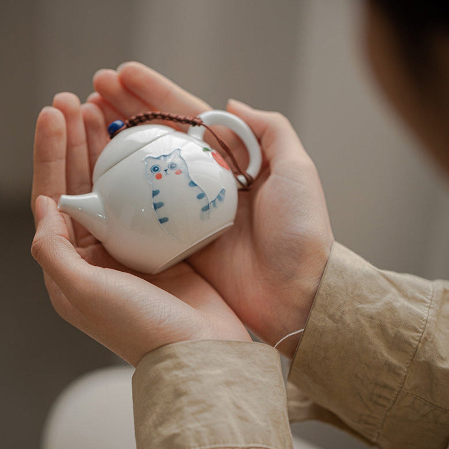 holding a cute teapot