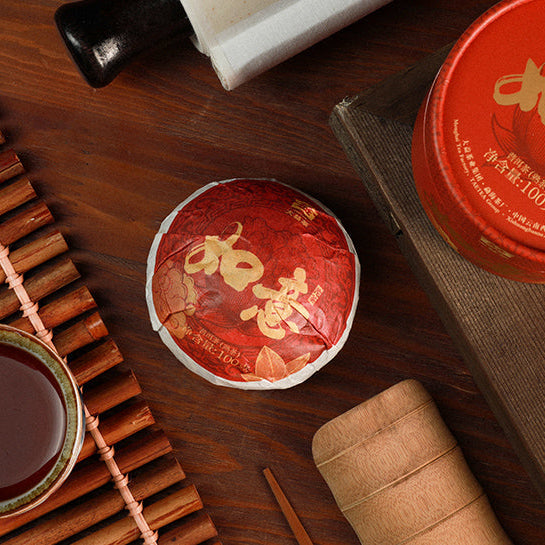 Taetea Ruyi tuocha, compressed ripe pu erh on a table