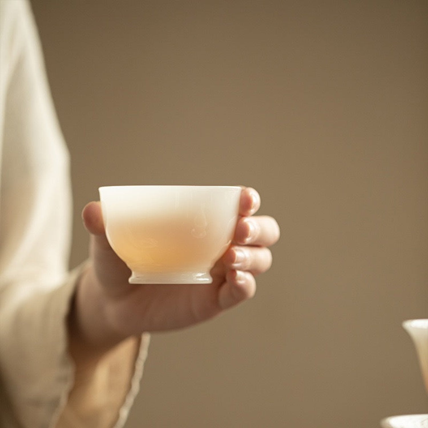 tea soup visible from the jade porcelain tea cup walls
