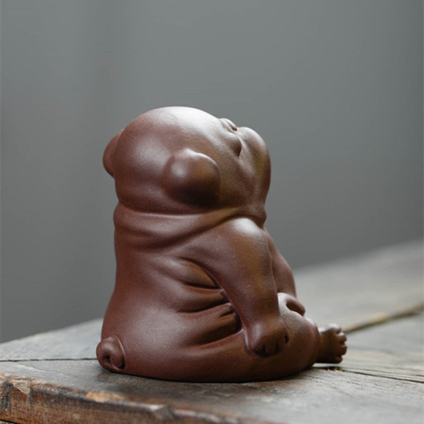 lazy dog clay figurine