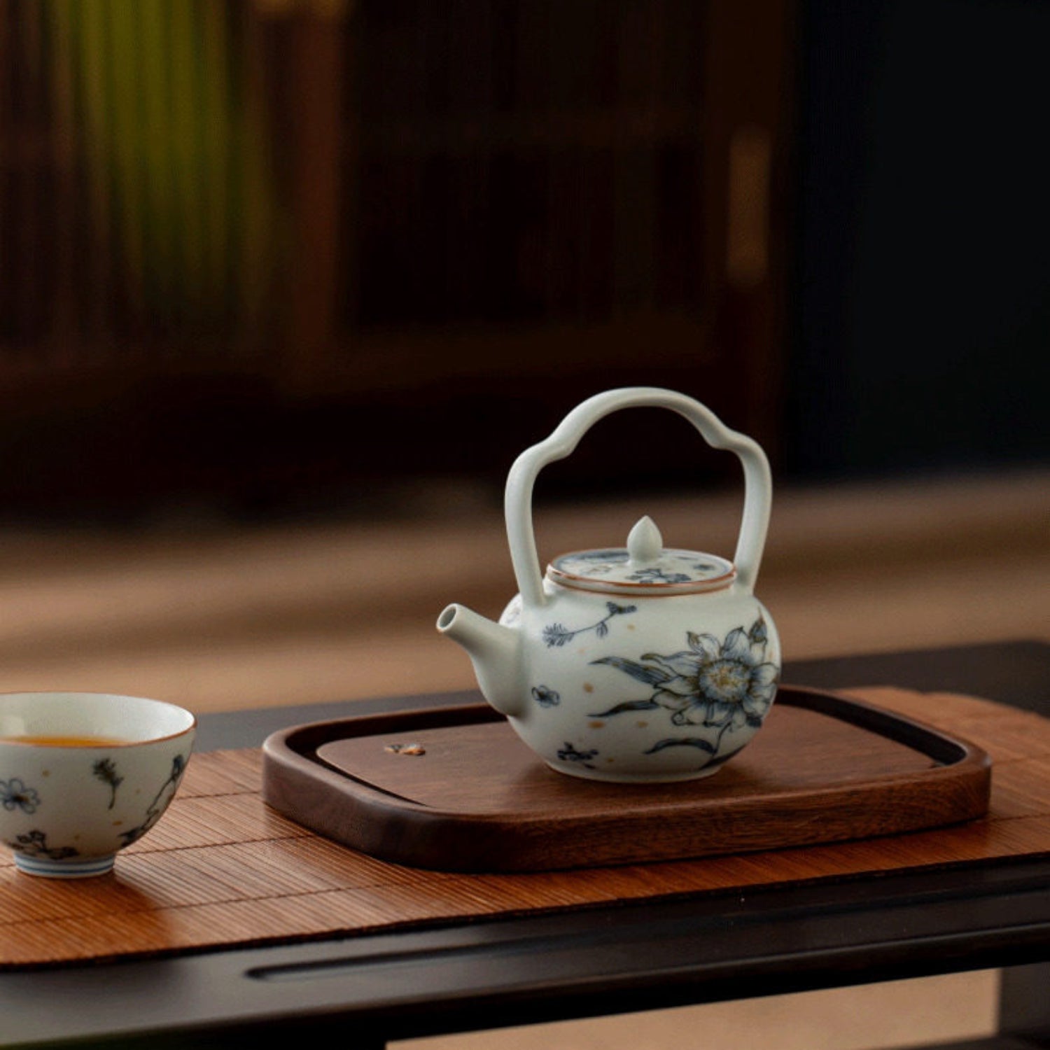 retro blue teapot with sunflower design and built-in handle