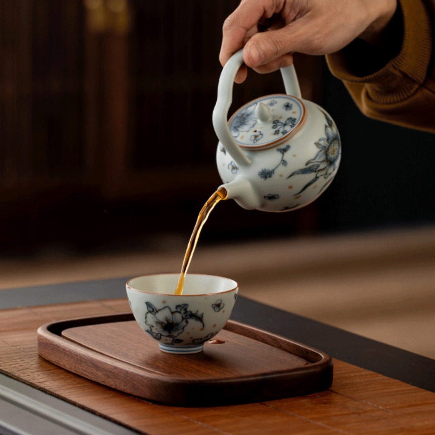 pouring tea with a retro style ceramic teapot