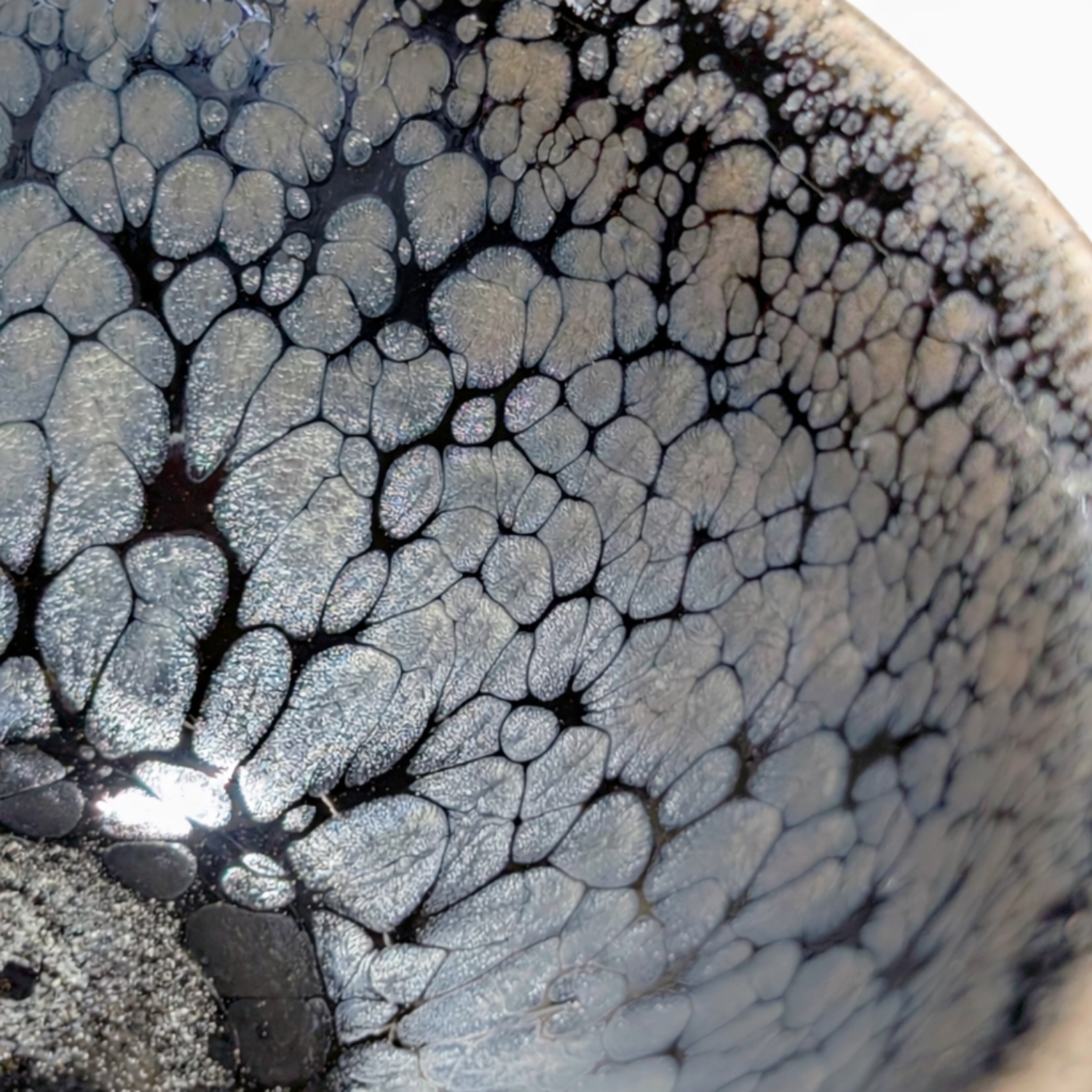 close up of a tenmoku tea cup glaze