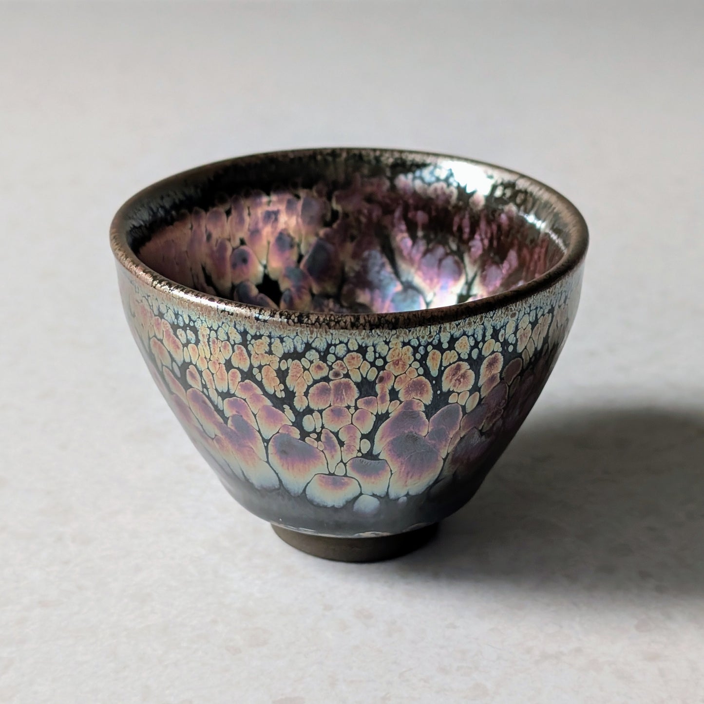 a jian zhan tea cup with pink flower glazing