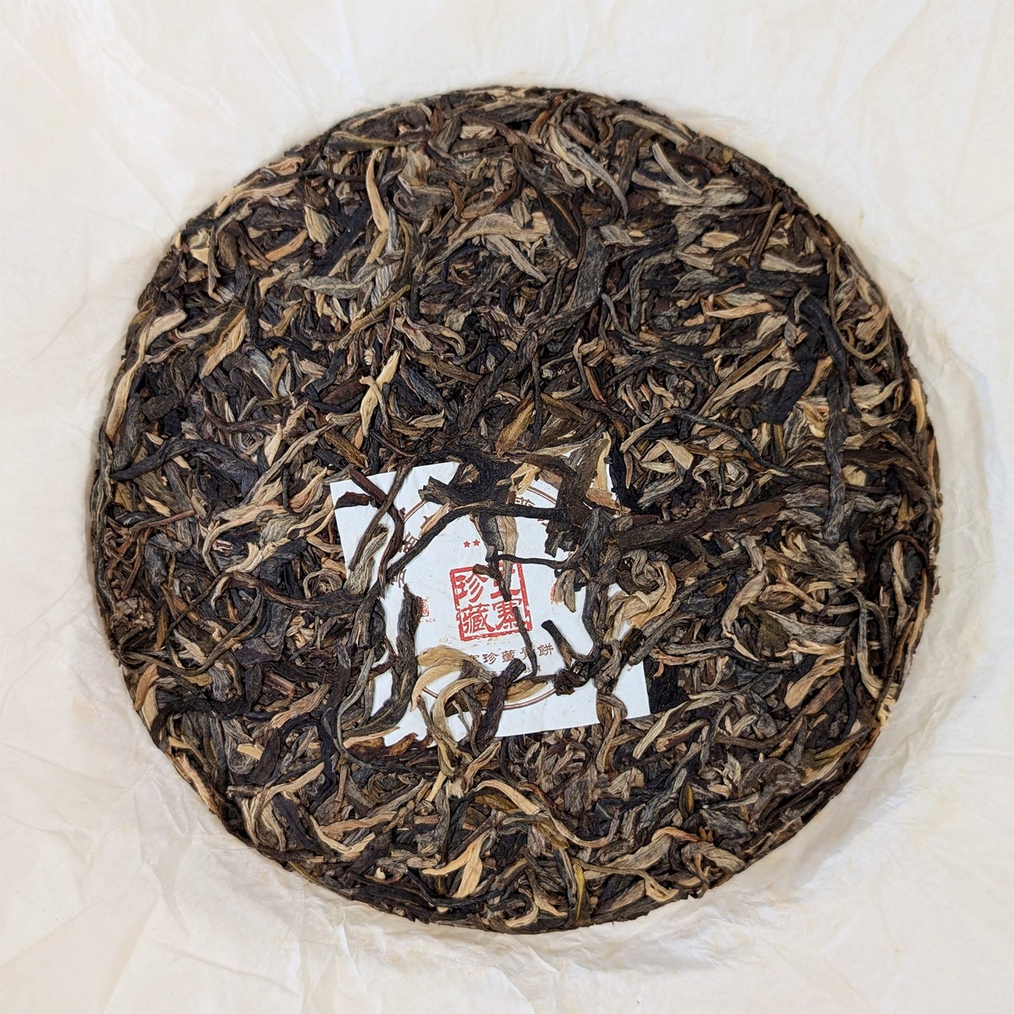 raw pu erh cake with golden buds 