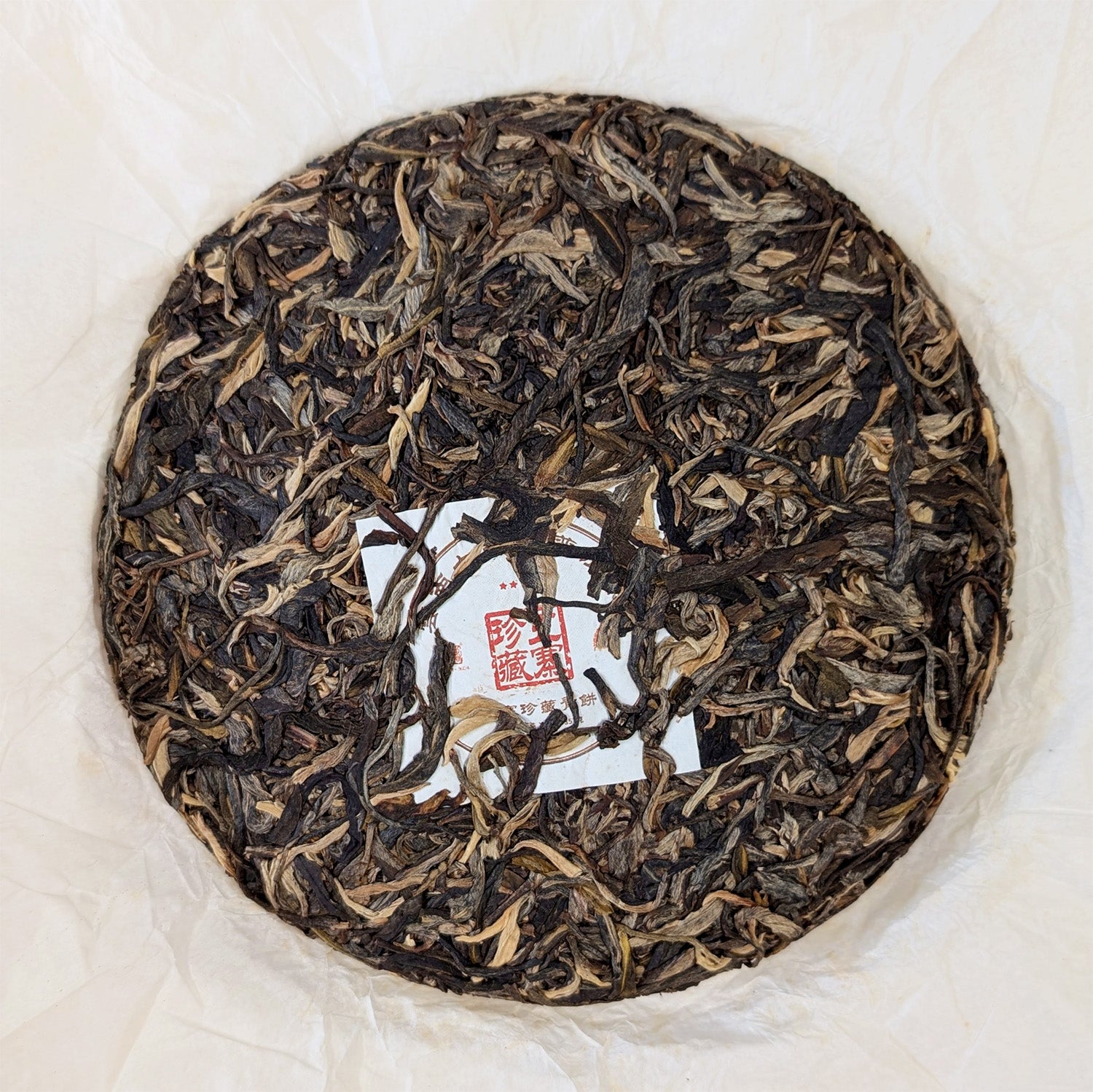 raw pu erh cake with golden buds 