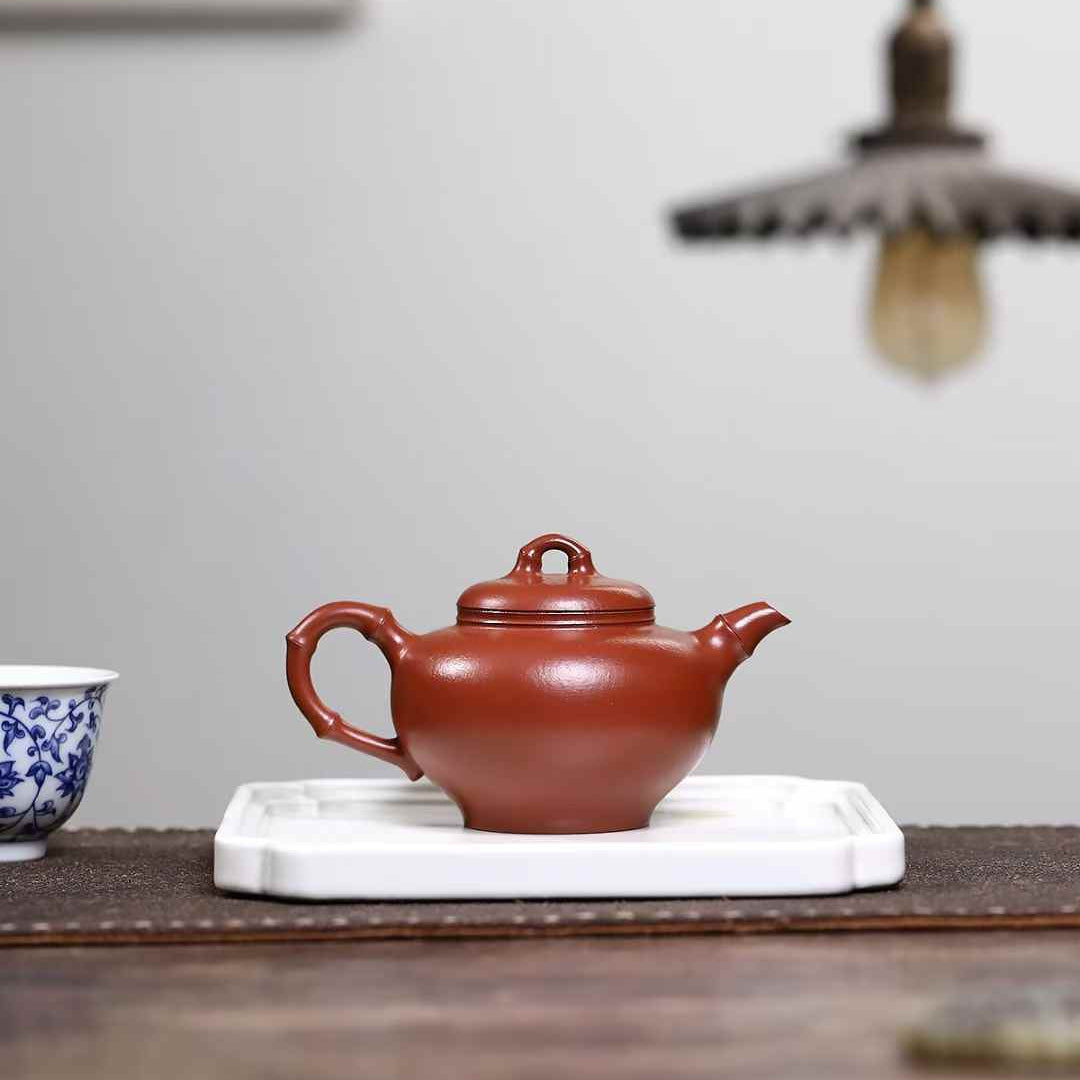 red clay Yixing tea pot with a bamboo  shaped handle 