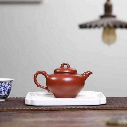 red clay Yixing tea pot with a bamboo  shaped handle 