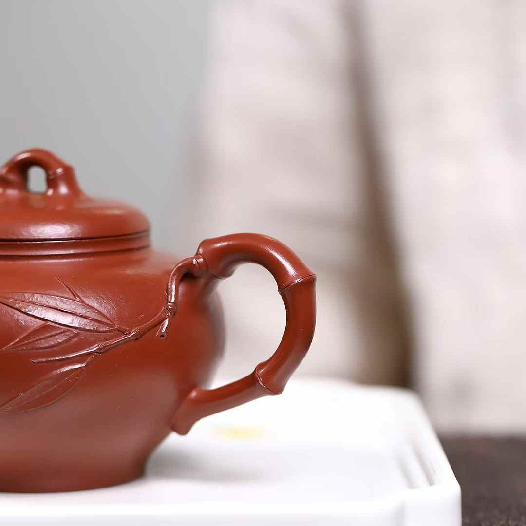 detail of a teapot's handle, which is bamboo-shaped