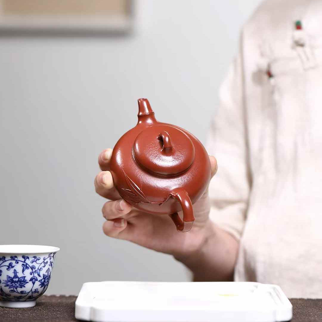 A Yixing teapot shown by a woman